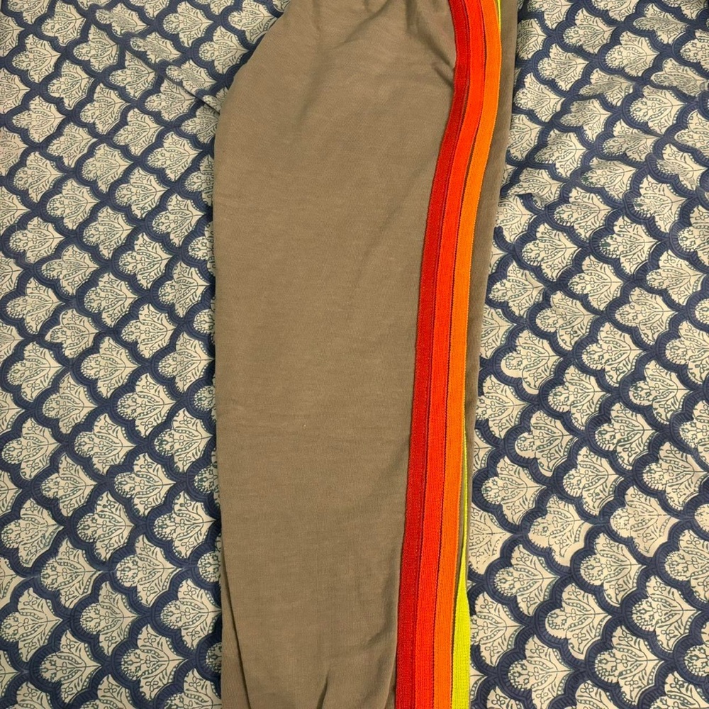 gray aviator nation pants with orange/red/pink stripes